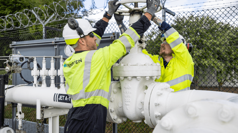 Two technicians working on an aviation fuel pipeline